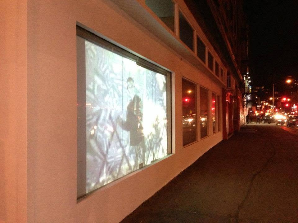 Night-time projection along a storefront