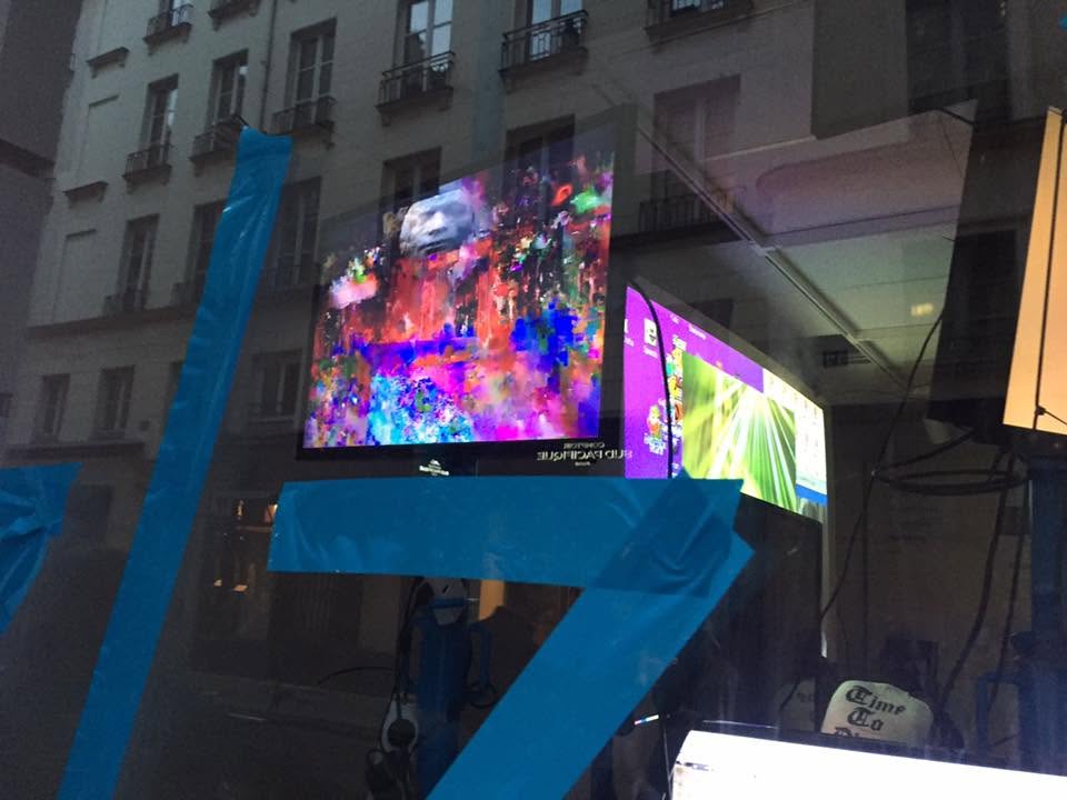 Digital artworks displayed behind a gallery window